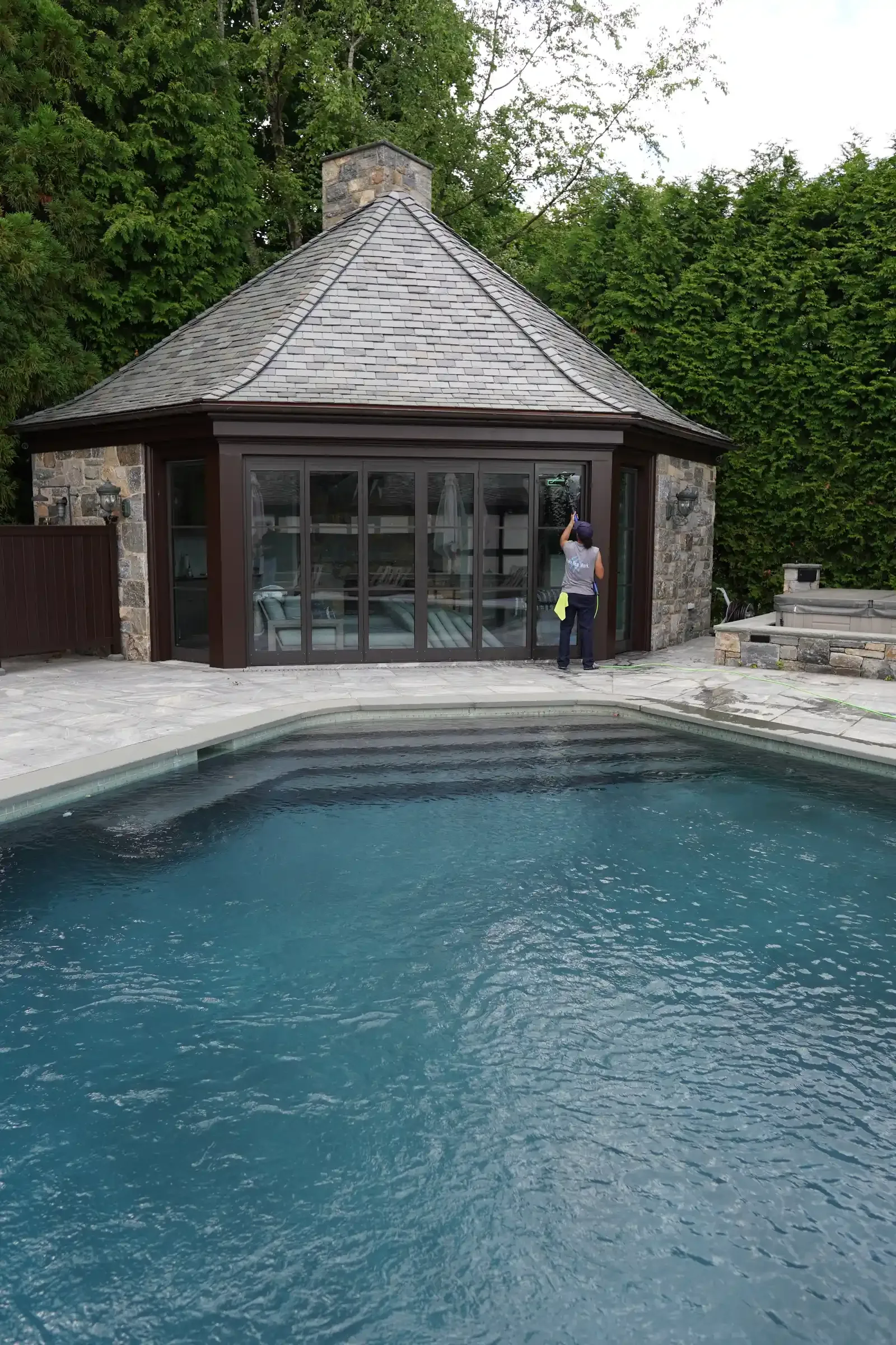 Poolside glass pavilion with spotless windows in Westchester County