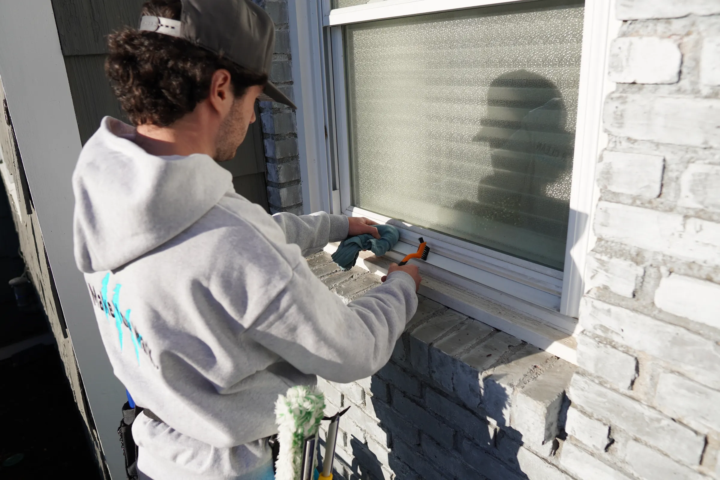 Close-up of a window track being detailed along the sill