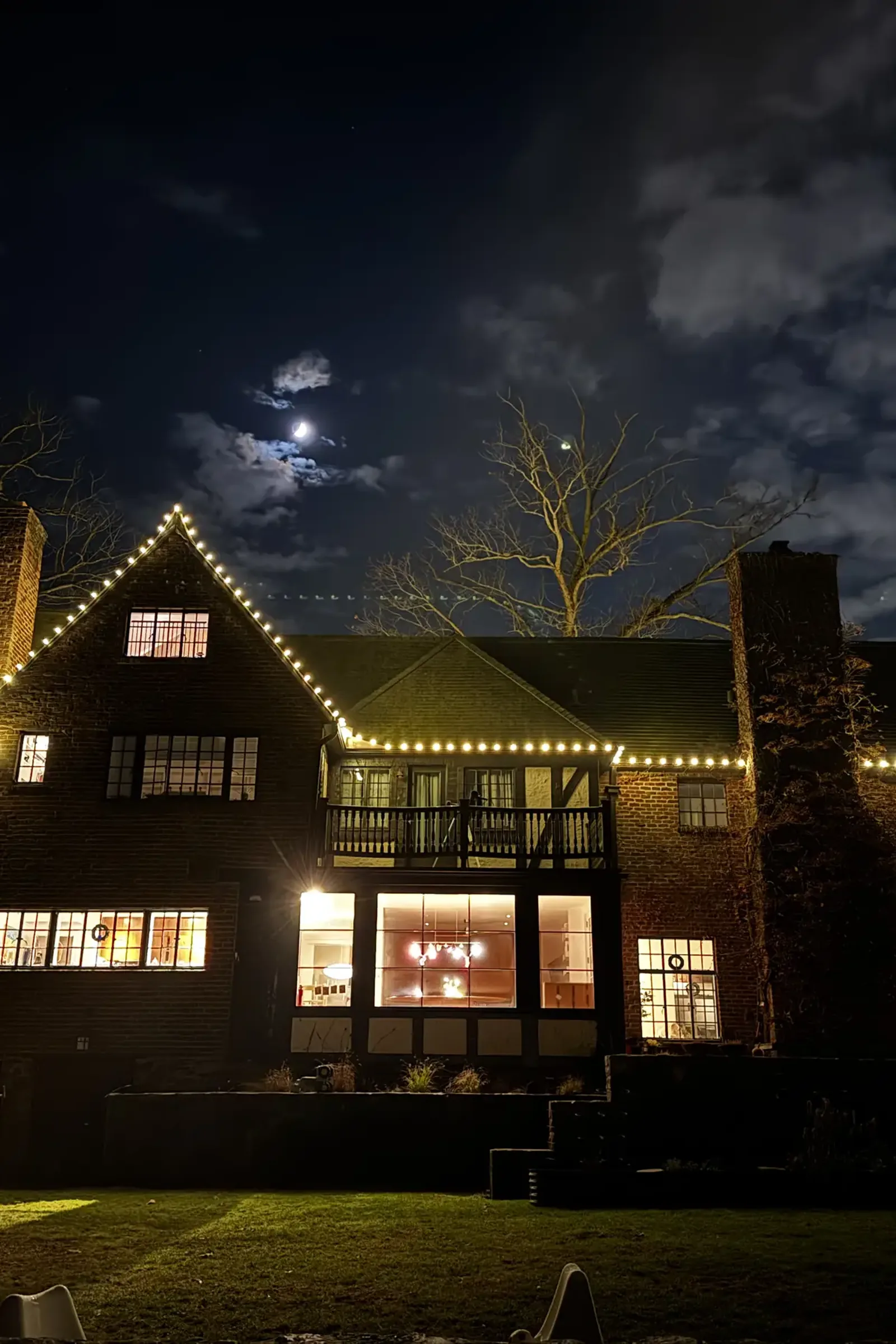 Tudor estate outlined in warm white Christmas roofline lighting