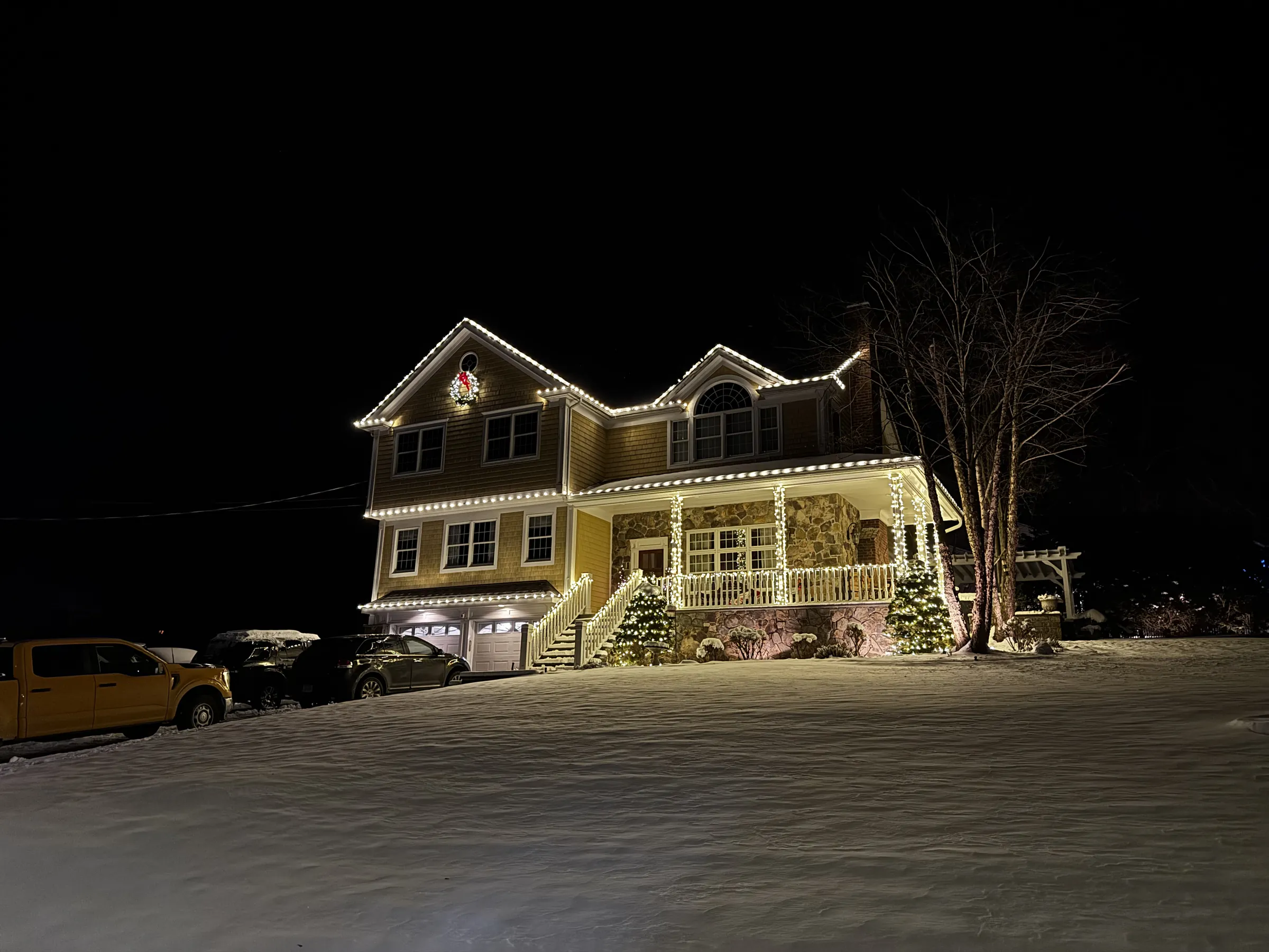 Finished Westchester home at dusk, glass and roofline lighting complete